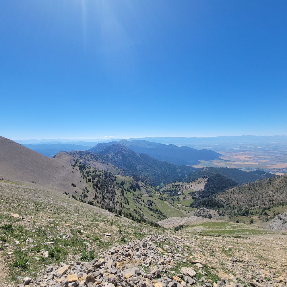 A sagebrush ridgeline above a broad farmed valley